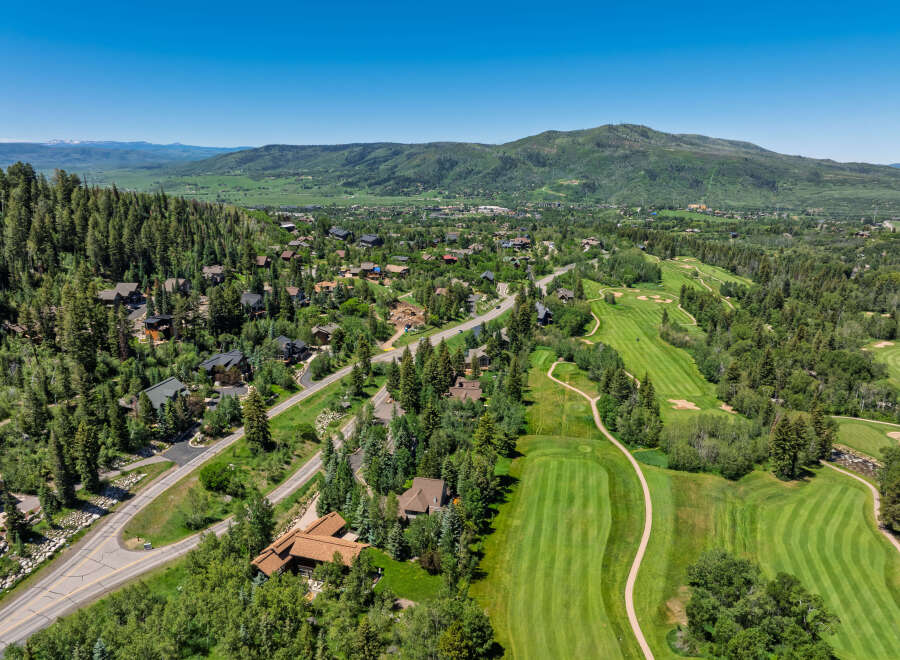 Experience luxury mountain living in this stunning property nestled amidst a picturesque golf course and lush evergreen forests.