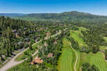 Experience luxury mountain living in this stunning property nestled amidst a picturesque golf course and lush evergreen forests.