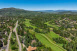 Experience luxury living nestled amidst a picturesque golf course and lush mountain scenery.