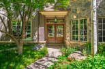 Experience the charm of this mountain home featuring a welcoming entrance with double wooden doors and a classic lantern.