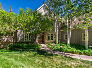 This charming mountain home features a rustic stone and wood exterior, perfect for a serene getaway.