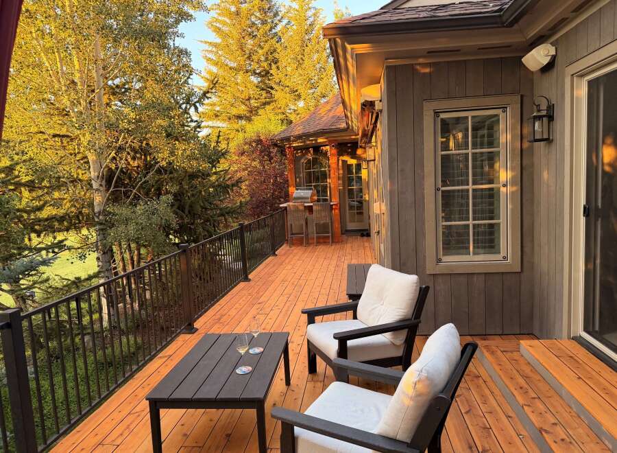 Enjoy the stunning mountain views from this expansive wooden deck, perfect for outdoor entertaining.