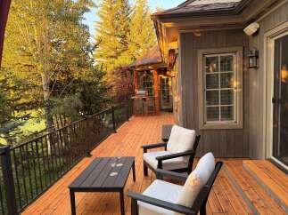 Enjoy the stunning mountain views from this expansive wooden deck, perfect for outdoor entertaining.