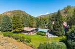 Nestled amidst a serene mountain landscape, this property offers a tranquil retreat with stunning natural beauty.