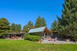Experience serene living in this charming property featuring a main house and a guest house, both nestled amidst mature trees.