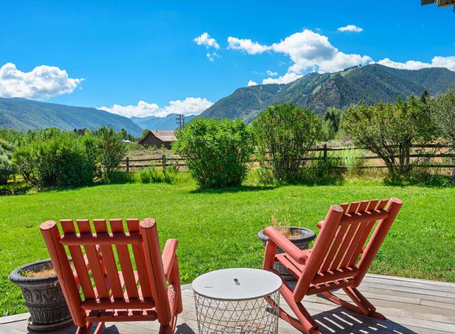 Enjoy breathtaking mountain views from this serene outdoor seating area, perfect for relaxing and taking in the scenery.