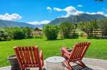 Enjoy breathtaking mountain views from this serene outdoor seating area, perfect for relaxing and taking in the scenery.