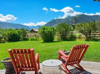 Enjoy breathtaking mountain views from this serene outdoor seating area, perfect for relaxing and taking in the scenery.