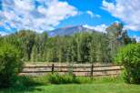 Experience the serene beauty of this property, nestled amidst lush greenery and offering breathtaking mountain views.