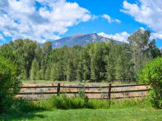 Experience the serene beauty of this property, nestled amidst lush greenery and offering breathtaking mountain views.