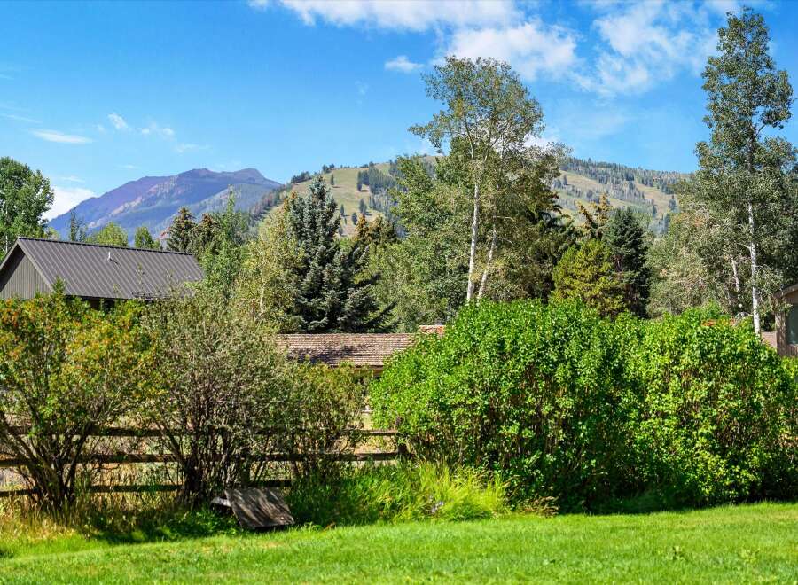 Nestled amidst lush greenery and mature trees, this property offers a serene mountain retreat.