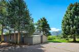Nestled amidst mature evergreen trees, this property offers a serene mountain retreat.