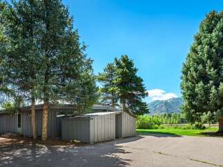Nestled amidst mature evergreen trees, this property offers a serene mountain retreat.