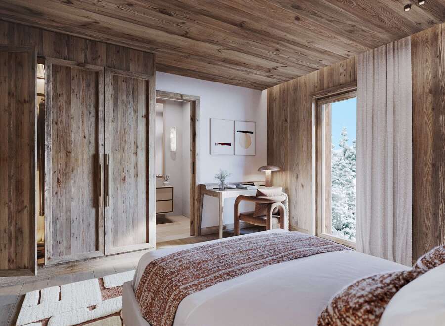 Experience rustic luxury in this charming bedroom, featuring warm wood paneling throughout and a cozy, inviting atmosphere.