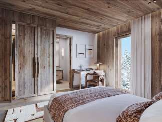 Experience rustic luxury in this charming bedroom, featuring warm wood paneling throughout and a cozy, inviting atmosphere.
