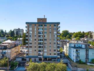 Discover this charming apartment building, featuring a classic mid-rise design with multiple balconies offering city views.
