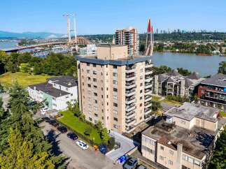 Discover this prime real estate opportunity featuring a multi-story apartment building with balconies and ample parking.