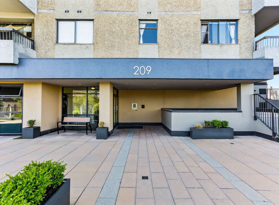 Discover modern living at this apartment building featuring a clean, contemporary facade with large windows and balconies.