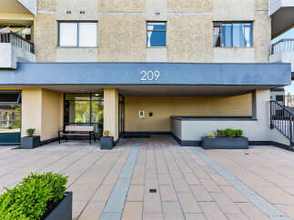 Discover modern living at this apartment building featuring a clean, contemporary facade with large windows and balconies.