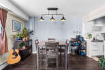 This dining area features a stylish gray table with four matching chairs, perfect for intimate meals.