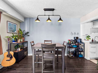 This dining area features a stylish gray table with four matching chairs, perfect for intimate meals.