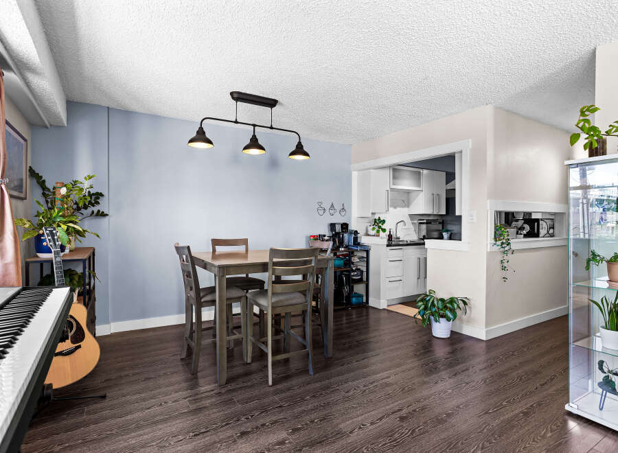 This open-concept living and dining area features a modern dining set perfect for intimate meals.