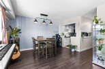 This open-concept living and dining area features a modern dining set perfect for intimate meals.