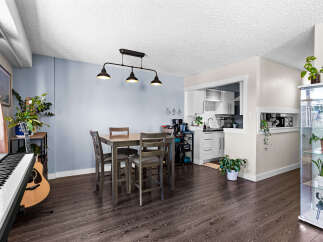 This open-concept living and dining area features a modern dining set perfect for intimate meals.