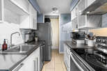Discover this modern kitchen featuring sleek white cabinetry and a stylish marble backsplash.