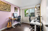 This home office features two distinct workspaces, perfect for collaboration or individual focus.