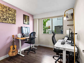 This home office features two distinct workspaces, perfect for collaboration or individual focus.