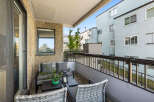 Enjoy your morning coffee on this charming balcony, complete with comfortable seating and a coffee table.
