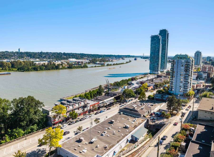 Experience urban living at its finest with this stunning aerial view of a vibrant waterfront community.