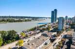 Experience urban living at its finest with this stunning aerial view of a vibrant waterfront community.