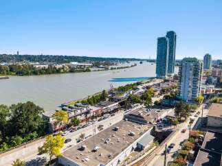 Experience urban living at its finest with this stunning aerial view of a vibrant waterfront community.