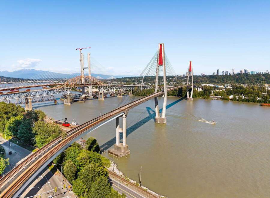Experience breathtaking views and seamless connectivity with this stunning waterfront property, featuring multiple bridges and a vibrant cityscape in the distance.