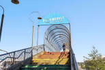 Discover the vibrant River Market in New Westminster, Canada, accessible via a colorful pedestrian bridge.