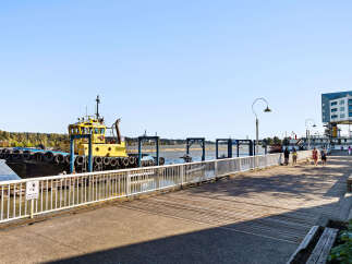 Enjoy waterfront living with this stunning property featuring a scenic boardwalk perfect for leisurely strolls and a vibrant marina.