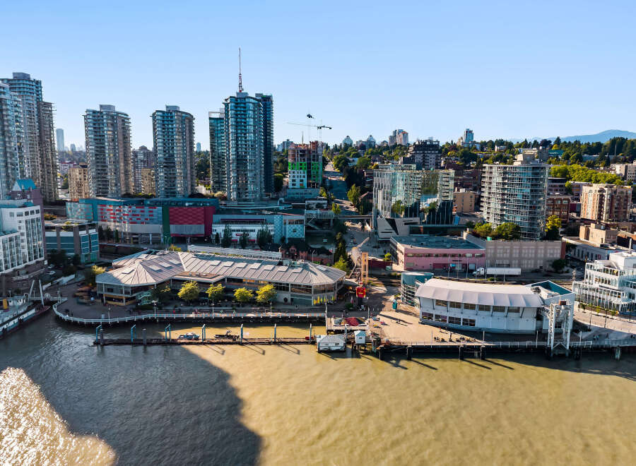 Experience waterfront living in this vibrant urban setting, featuring modern high-rise apartments with stunning city and water views.