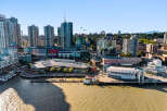 Experience waterfront living in this vibrant urban setting, featuring modern high-rise apartments with stunning city and water views.