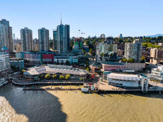 Experience waterfront living in this vibrant urban setting, featuring modern high-rise apartments with stunning city and water views.