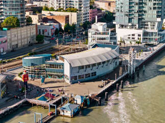 Experience waterfront living at its finest with this stunning property featuring modern architecture and expansive glass windows offering panoramic views.