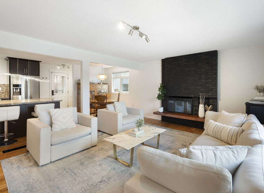 Experience modern living in this beautifully appointed open-concept home, featuring a sleek kitchen with stainless steel appliances and a breakfast bar.