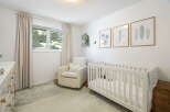 Welcome to this charming nursery, thoughtfully designed for comfort and style.