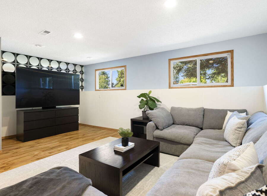 This basement living area offers a modern and comfortable entertainment space.
