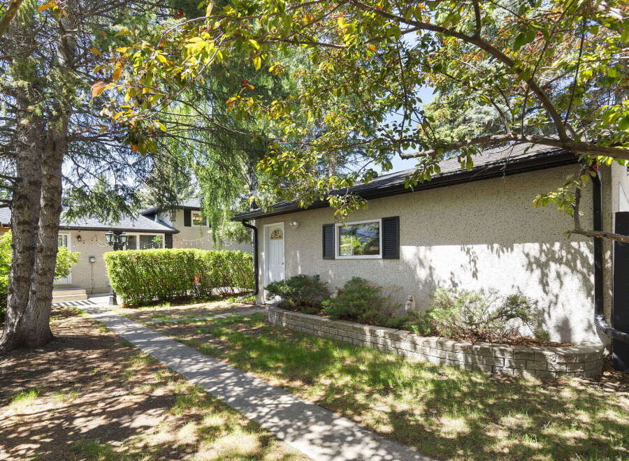 Discover this charming property featuring a well-maintained exterior with a textured stucco finish and a classic asphalt shingle roof.