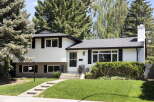 Charming white siding home with black shutters and a welcoming front entrance.
