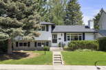 Charming white siding home with black shutters and a welcoming front entrance.