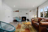 This inviting living room features a cozy brick fireplace, perfect for chilly evenings.