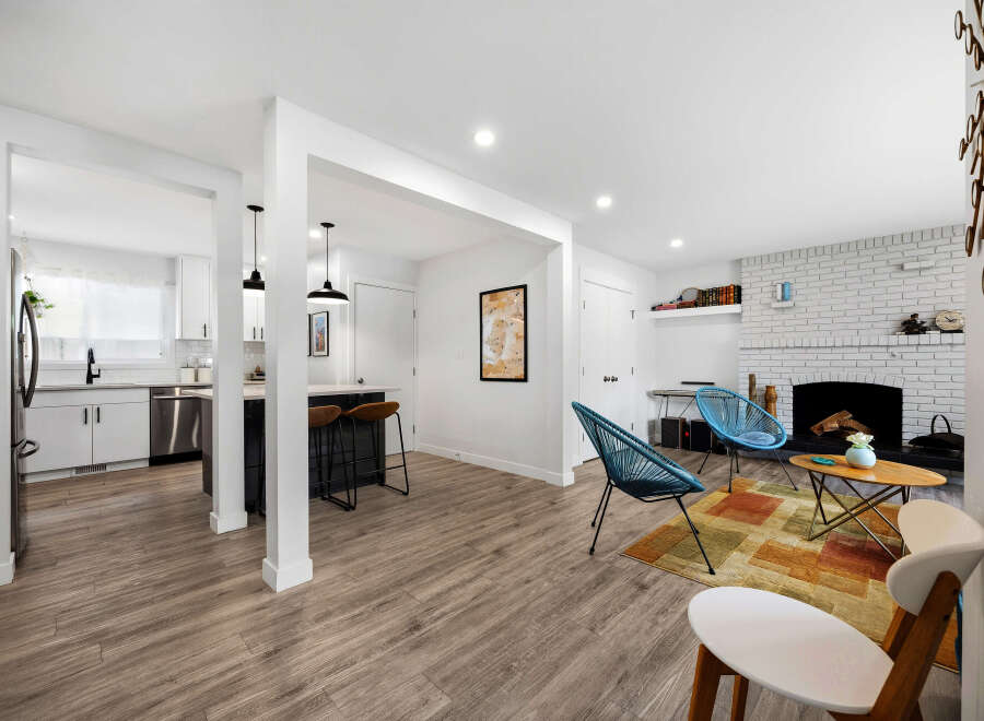 Discover modern living in this beautifully renovated open-concept space, featuring a sleek kitchen with stainless steel appliances and a stylish island perfect for casual dining.